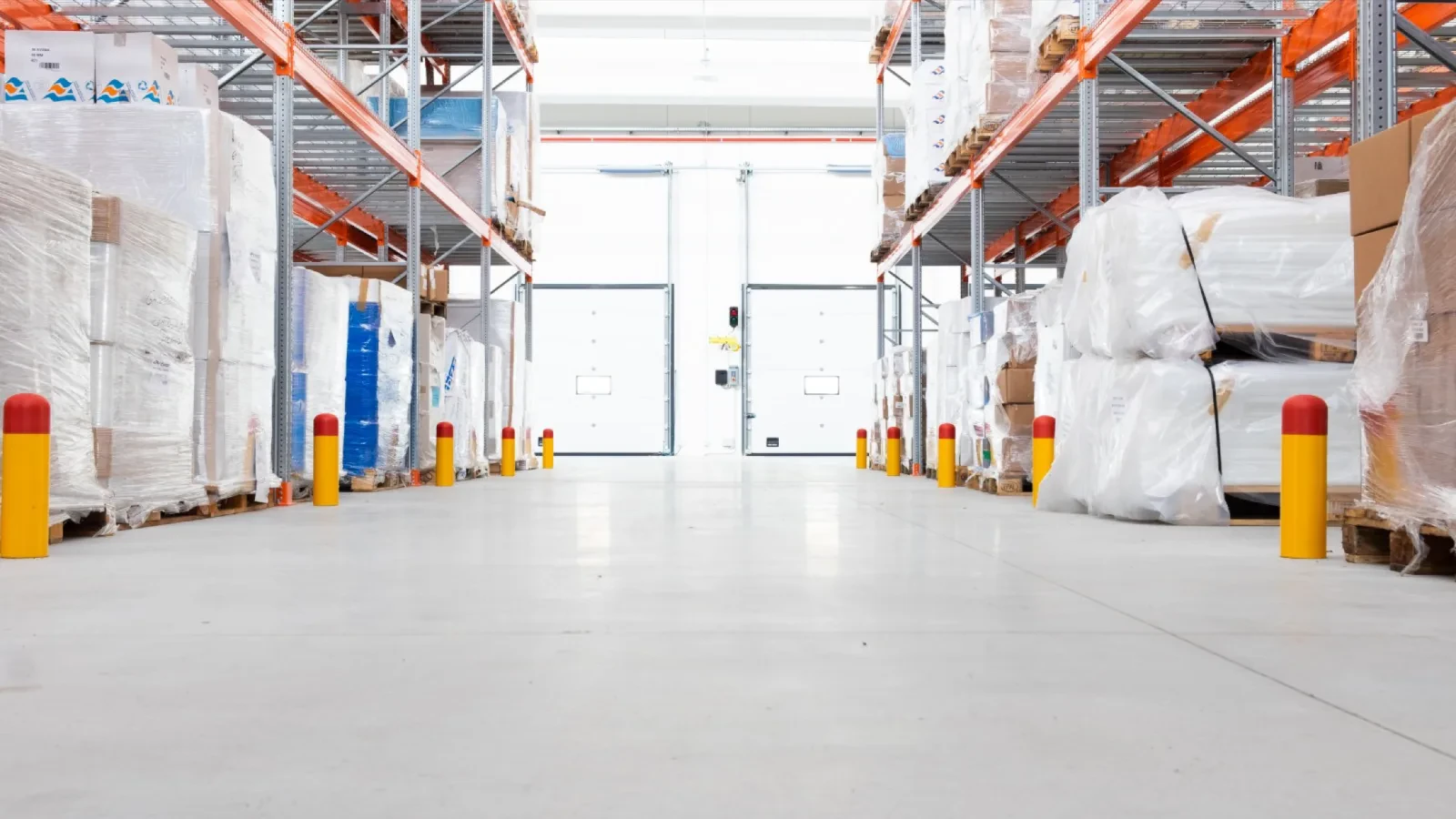 Protective bollards at the ends of a rack aisle